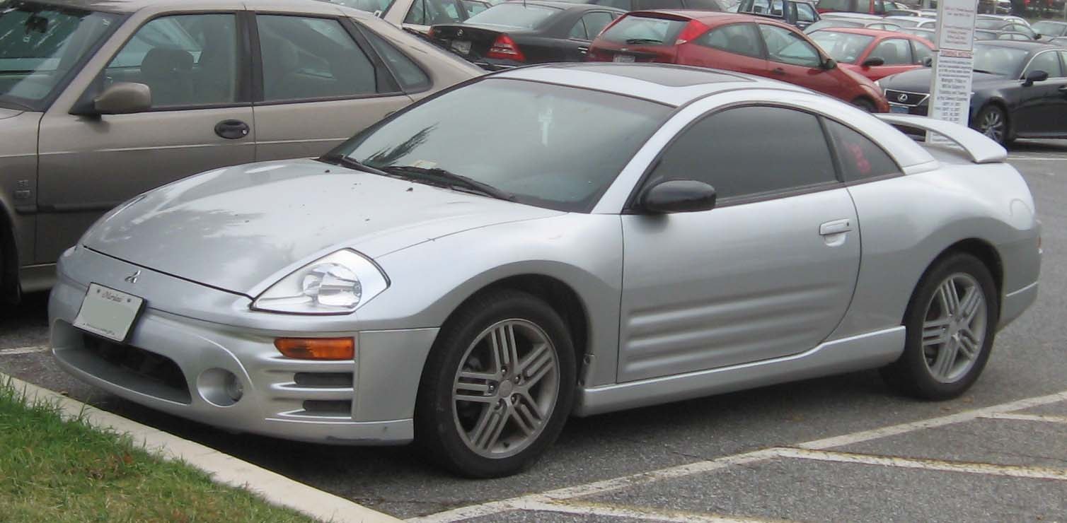 Silver sporty coupe with distinctive headlights and rear spoiler