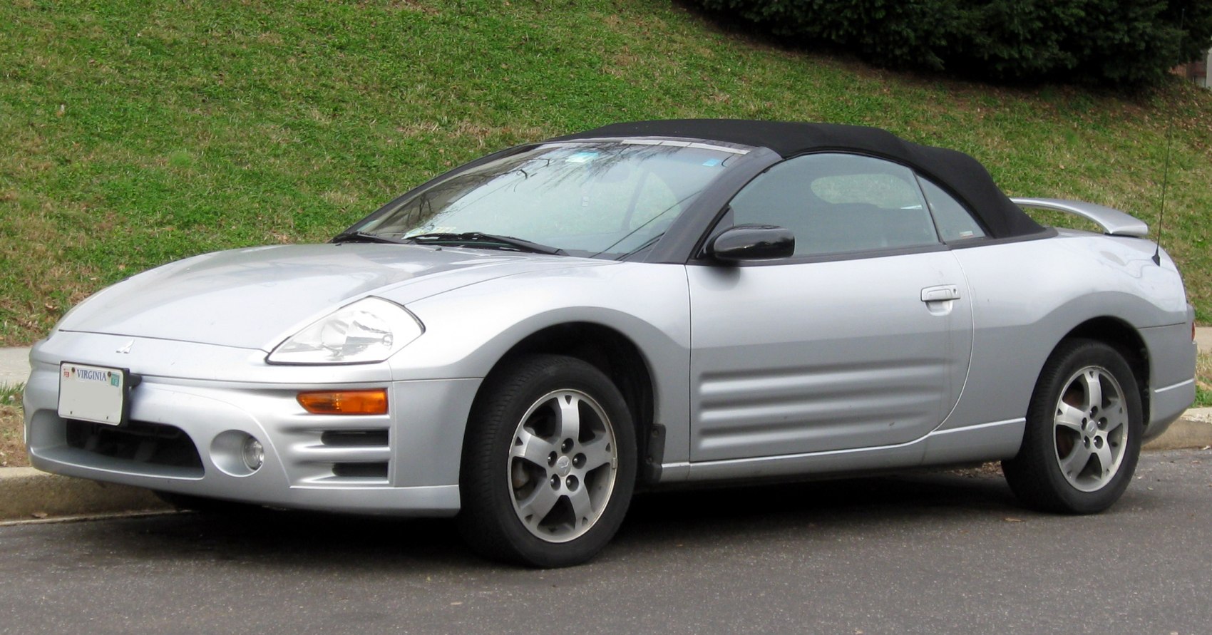 Silver convertible coupe with rounded headlights and soft top.