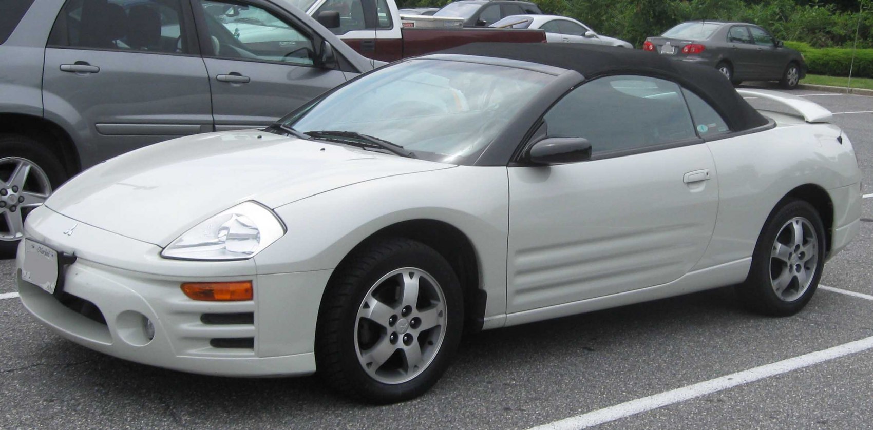 Sporty convertible with black soft top and sculpted front side design