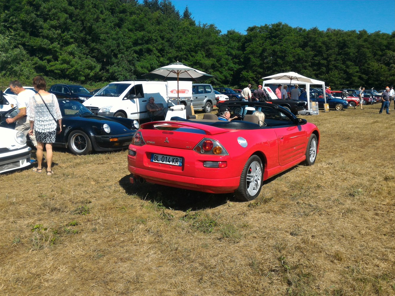 Rear view of red convertible sports car with spoiler and unique taillights