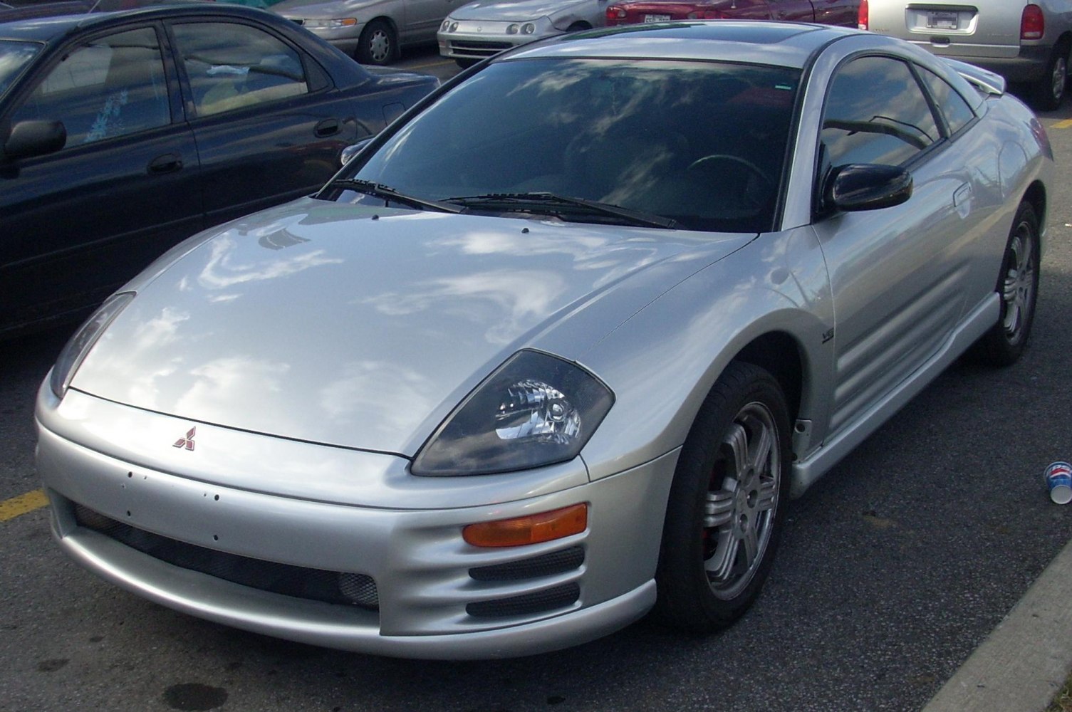 Silver sports coupe with aerodynamic headlights and sleek body.