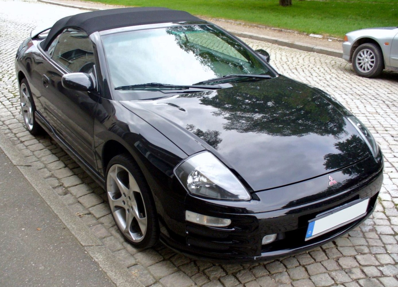 Front side view of black convertible with alloy wheels