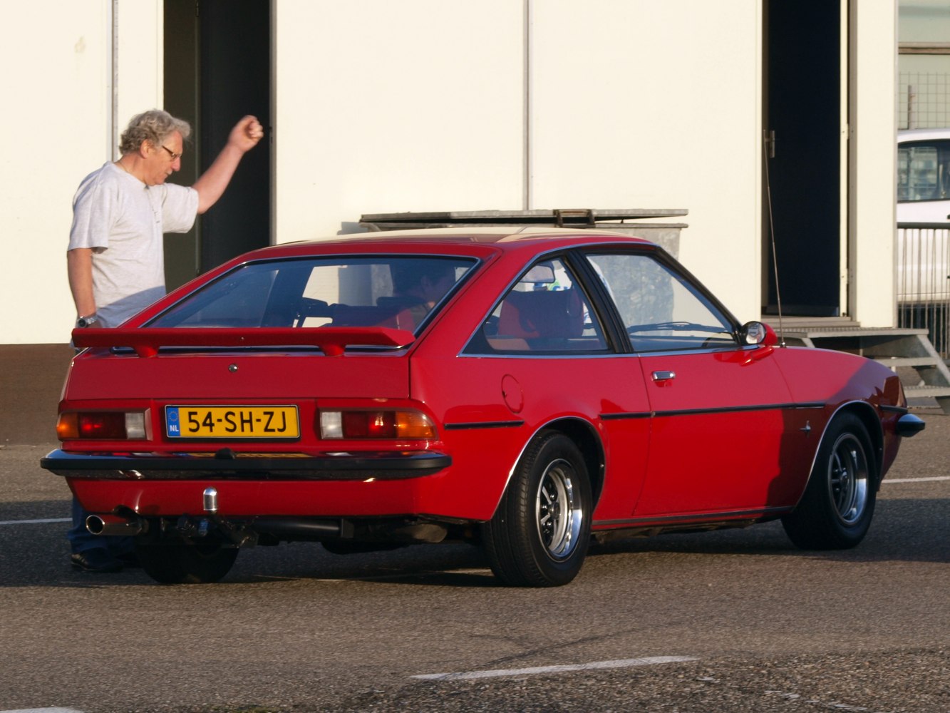 Red two-door coupe rear view with spoiler and vintage tail lights