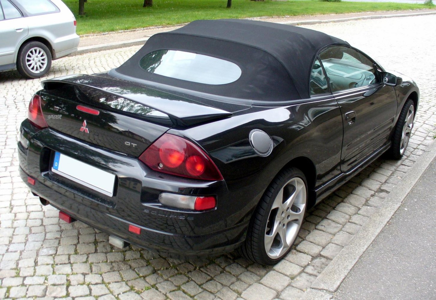 Black convertible with soft top and rear spoiler