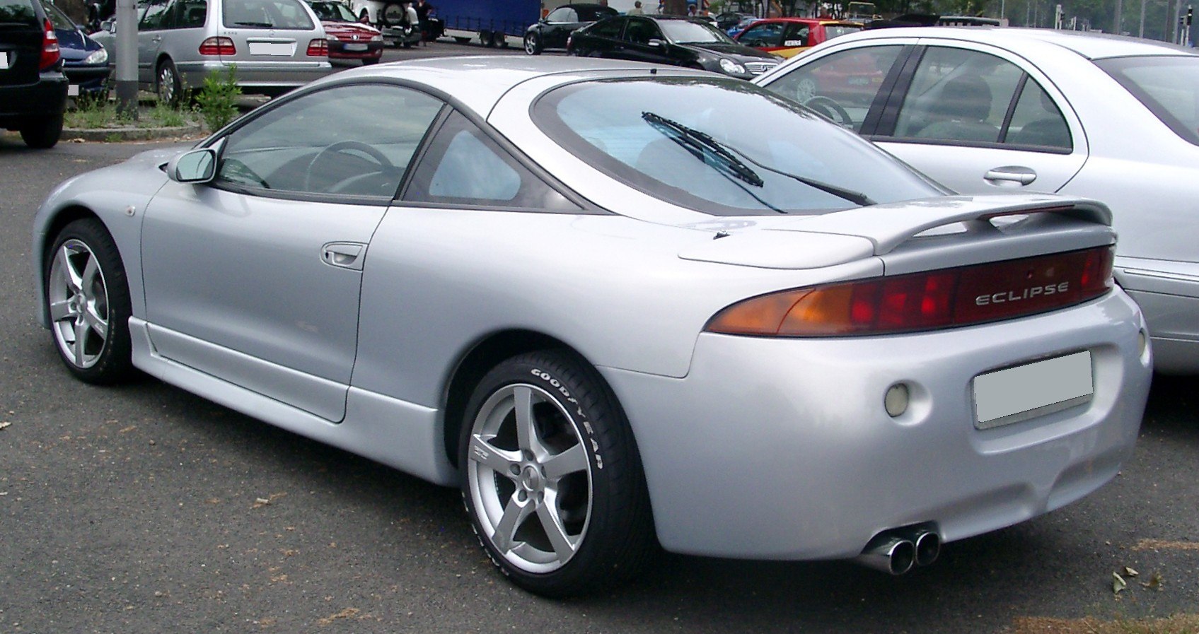 Silver 1997 sport coupe rear side view with spoiler and alloy wheels