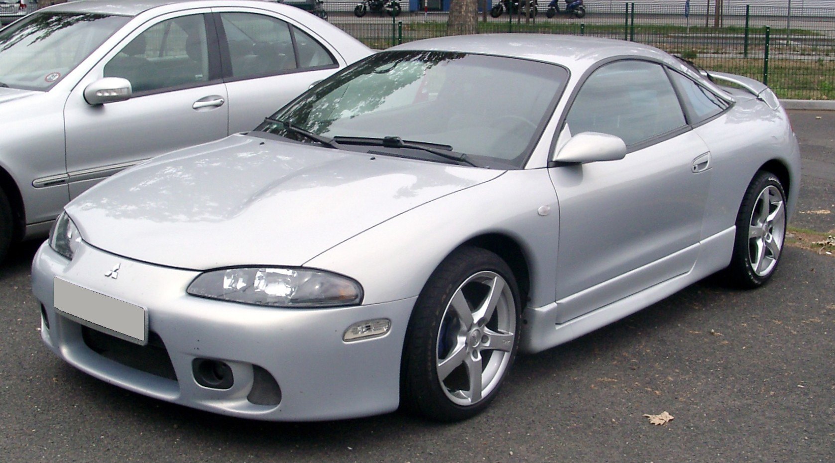 Silver sporty coupe with aerodynamic body and alloy wheels