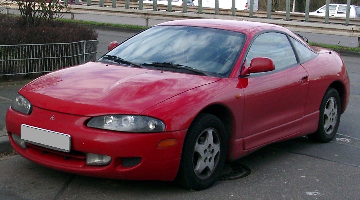 Red aerodynamic coupe with alloy wheels and sleek front design