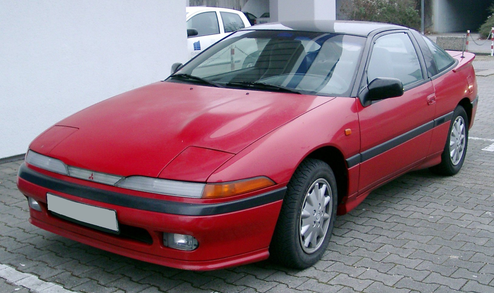 Front side view with pop-up headlights and sporty coupe design