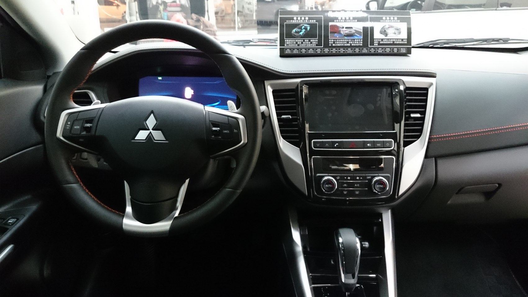 Steering wheel and dashboard with central touchscreen and control panels