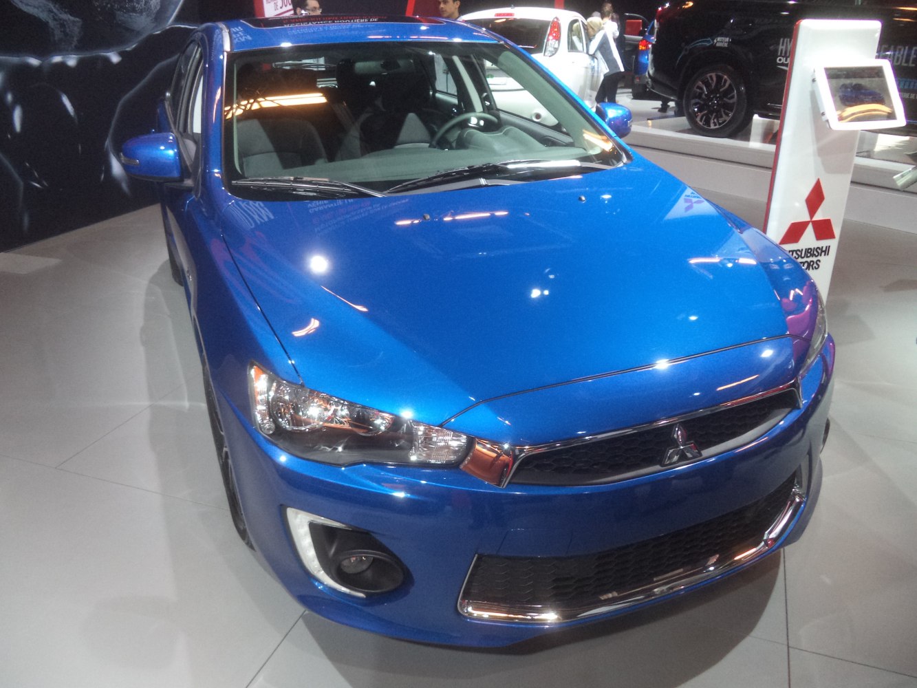 Blue hatchback with aggressive front grille and LED fog lights