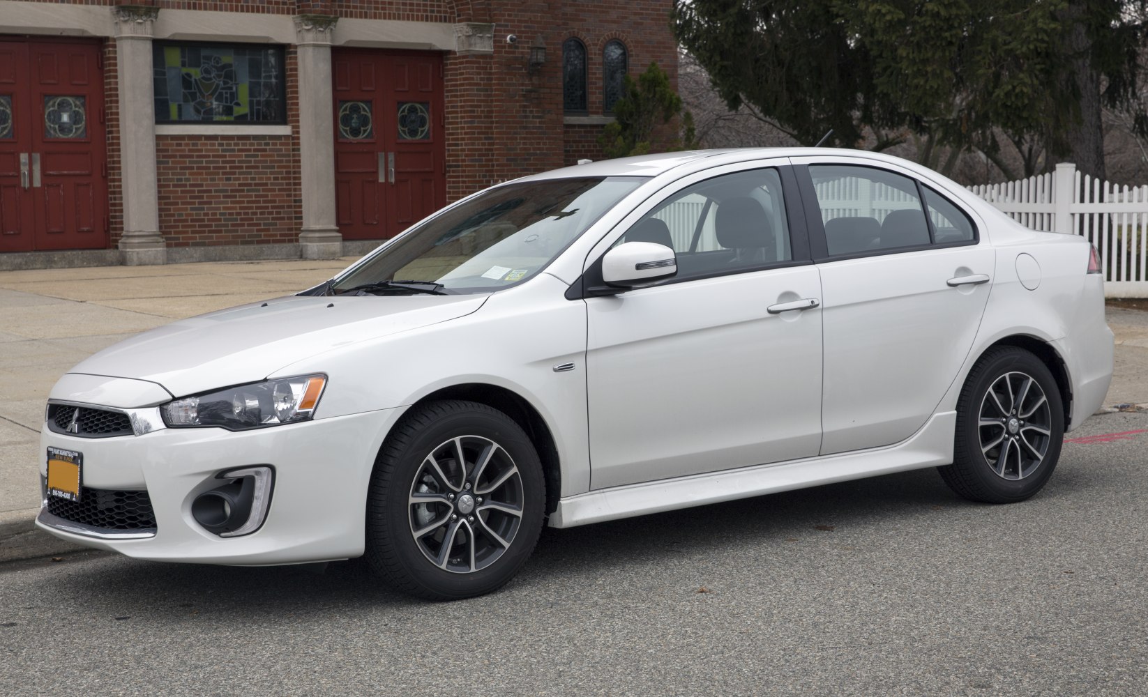 White sedan with alloy wheels and clear sharp headlights