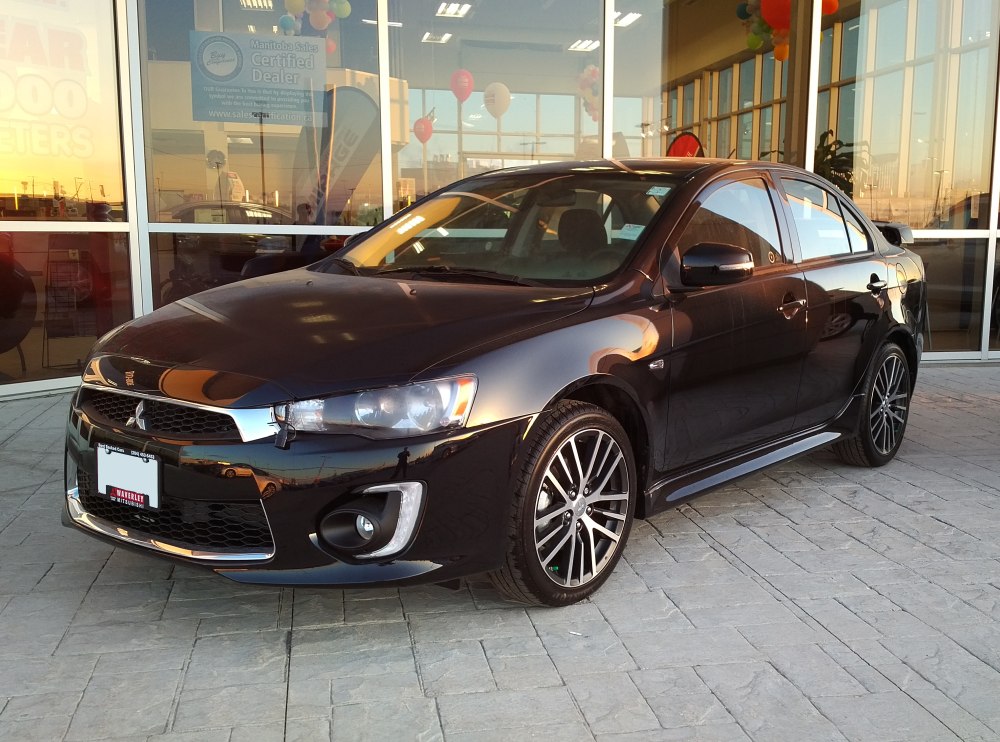 Sporty black sedan with alloy wheels and fog lamps
