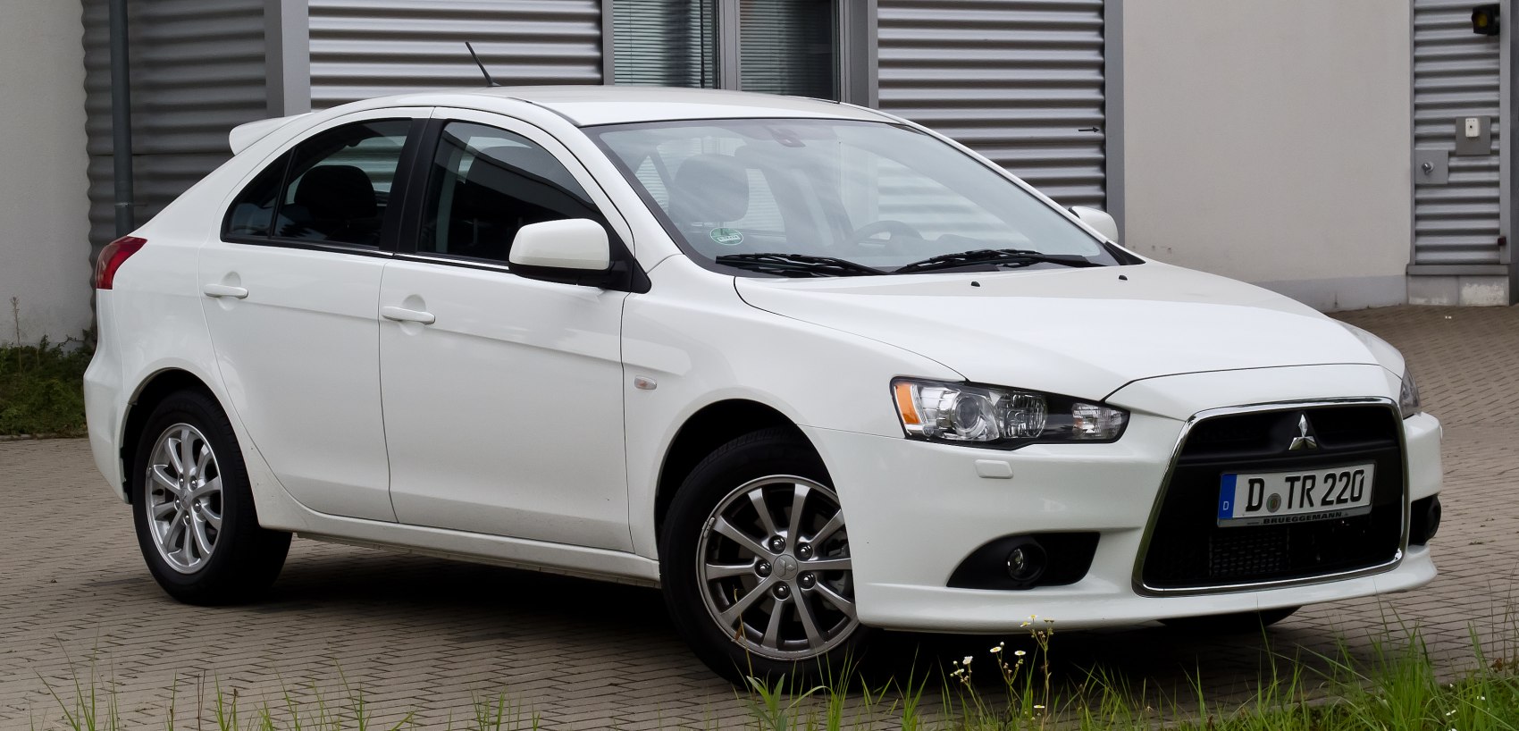 Compact hatchback with front and side view, featuring alloy wheels and distinct headlights