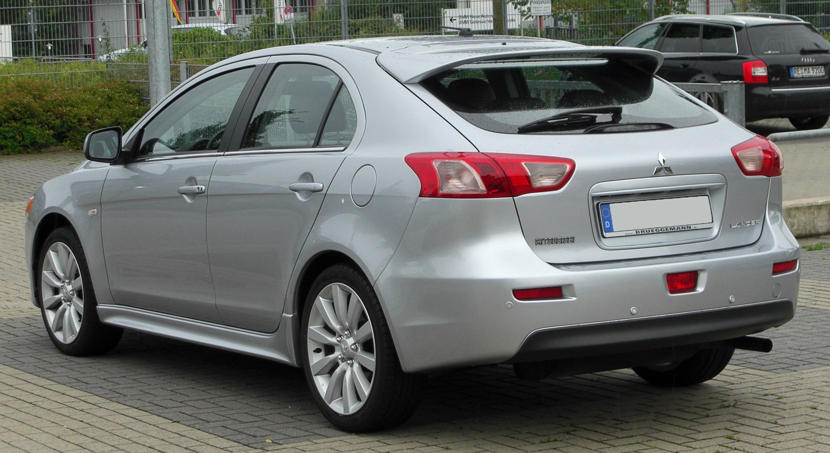 Silver hatchback rear side with spoiler and alloy wheels