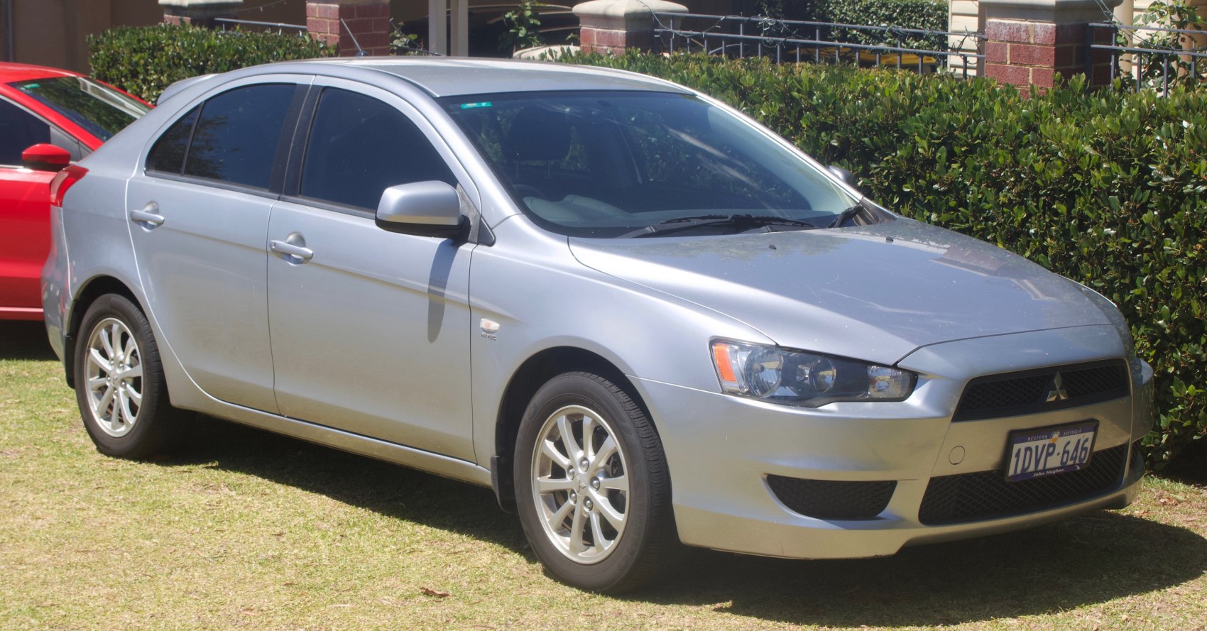 Silver compact hatchback with distinctive headlights and front grill