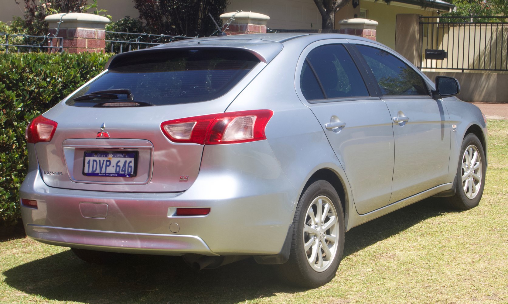 Rear and side view hatchback with distinct tail lights and rear wiper.