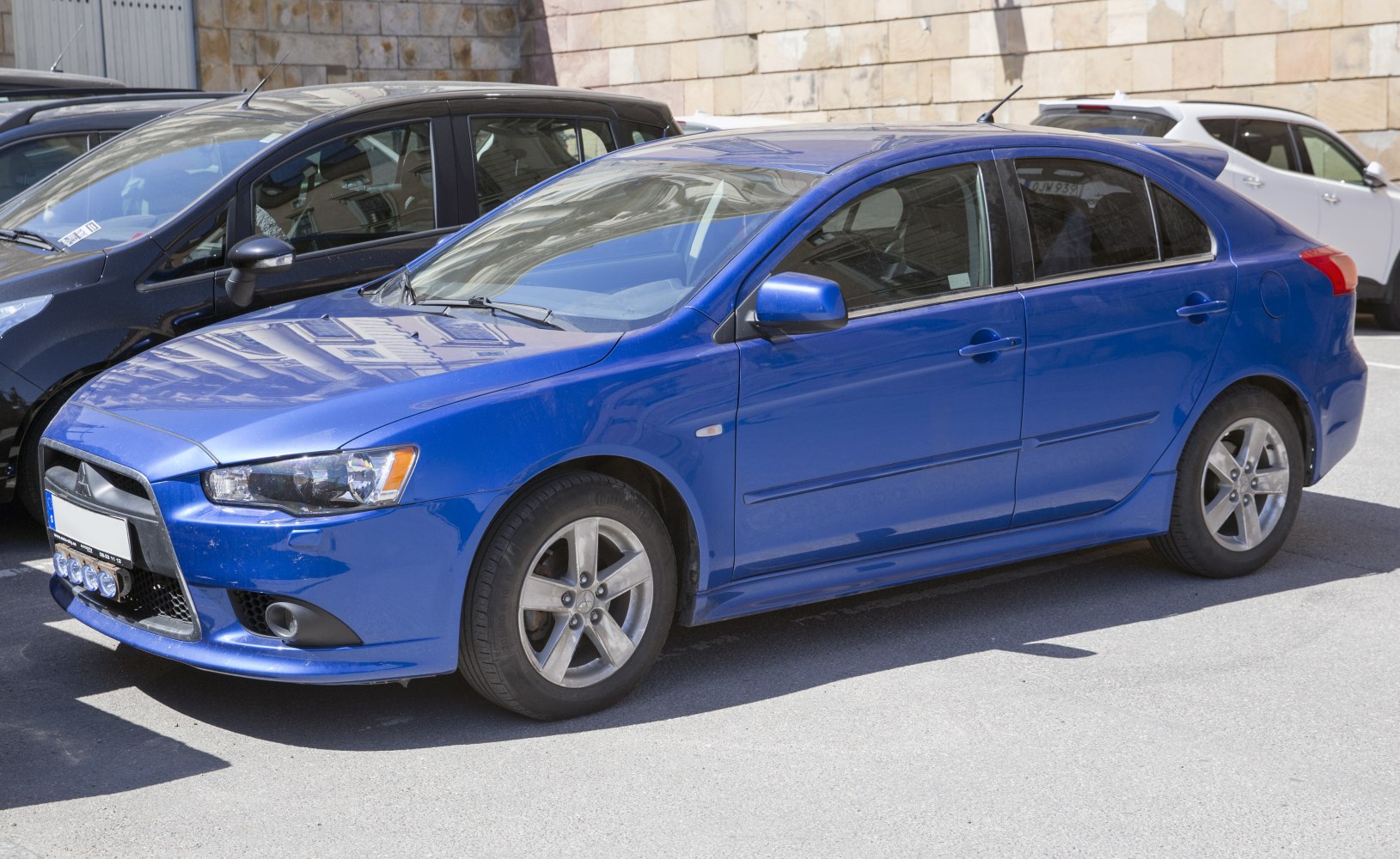 Blue sporty hatchback with distinct front grille and alloy wheels