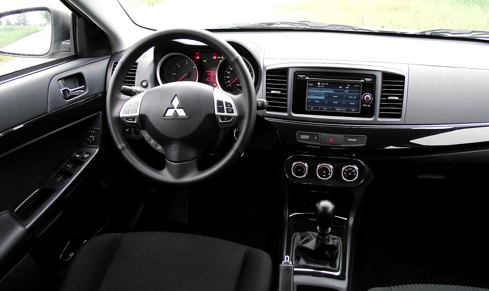 Steering wheel with controls and manual gear shifter