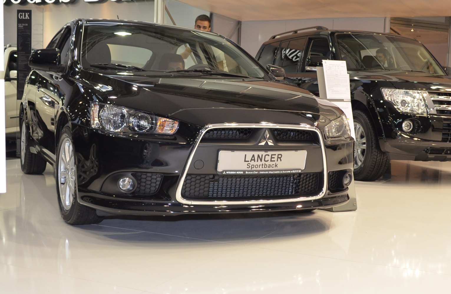 Front grill and headlights of black sedan