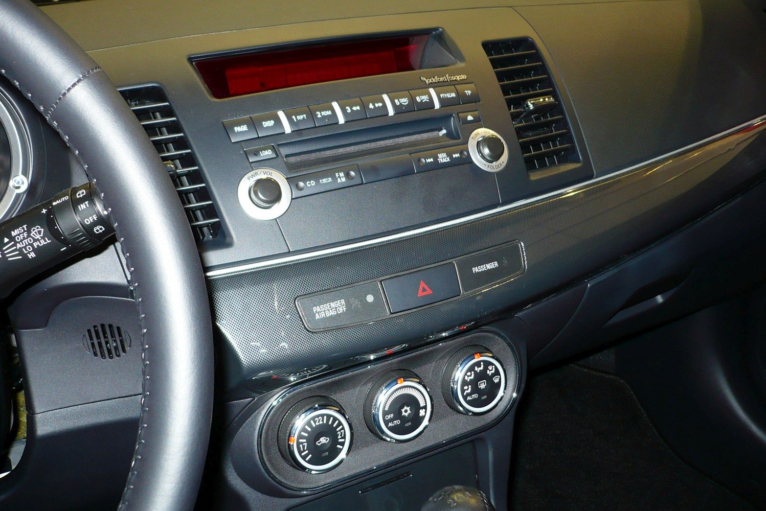 Car dashboard with climate control and audio system knobs