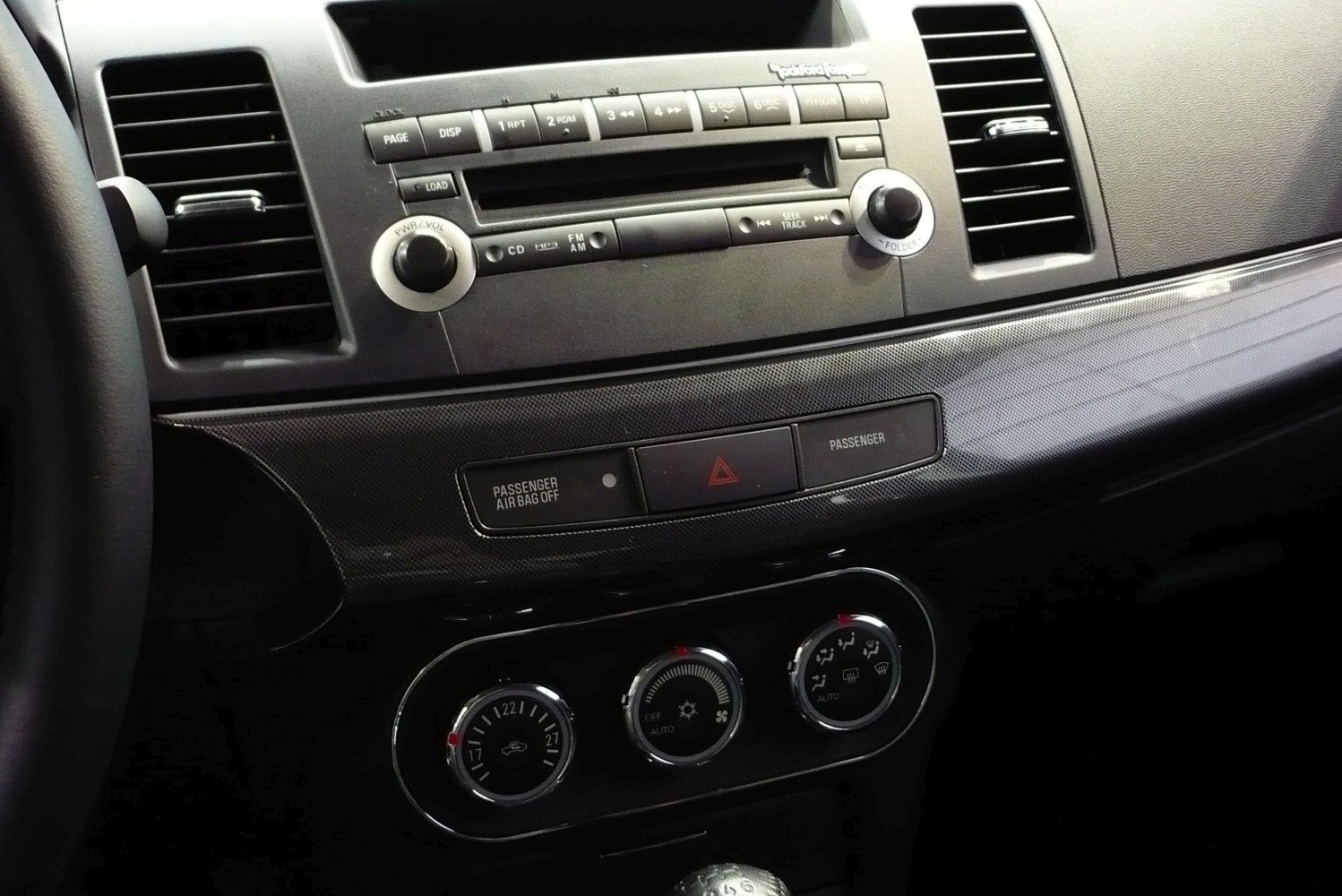 Climate control and audio interface with vents and dashboard buttons.