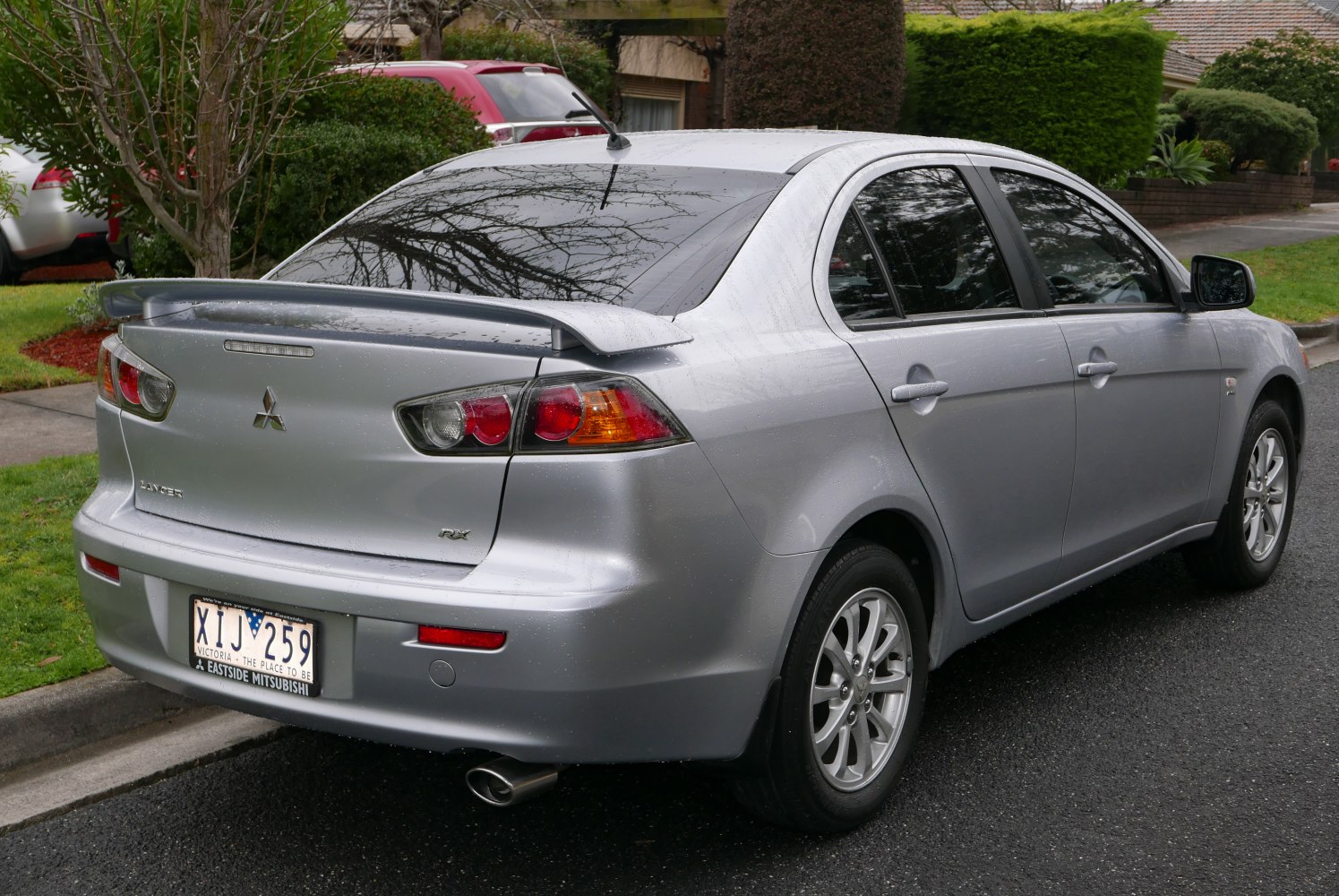 Silver sedan rear view with spoiler and alloy wheels
