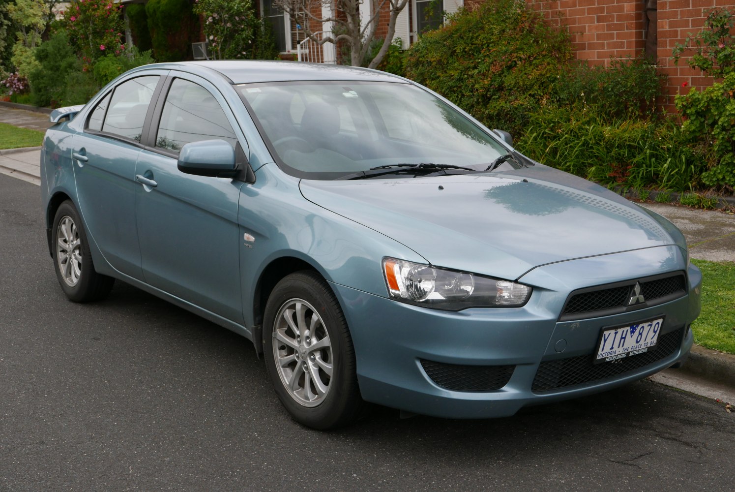 Front three-quarter view of a sedan with distinctive headlights and alloy wheels