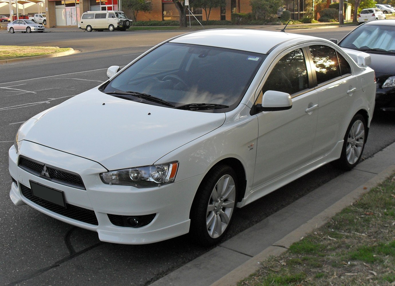 Sporty white sedan with aerodynamic body and alloy wheels