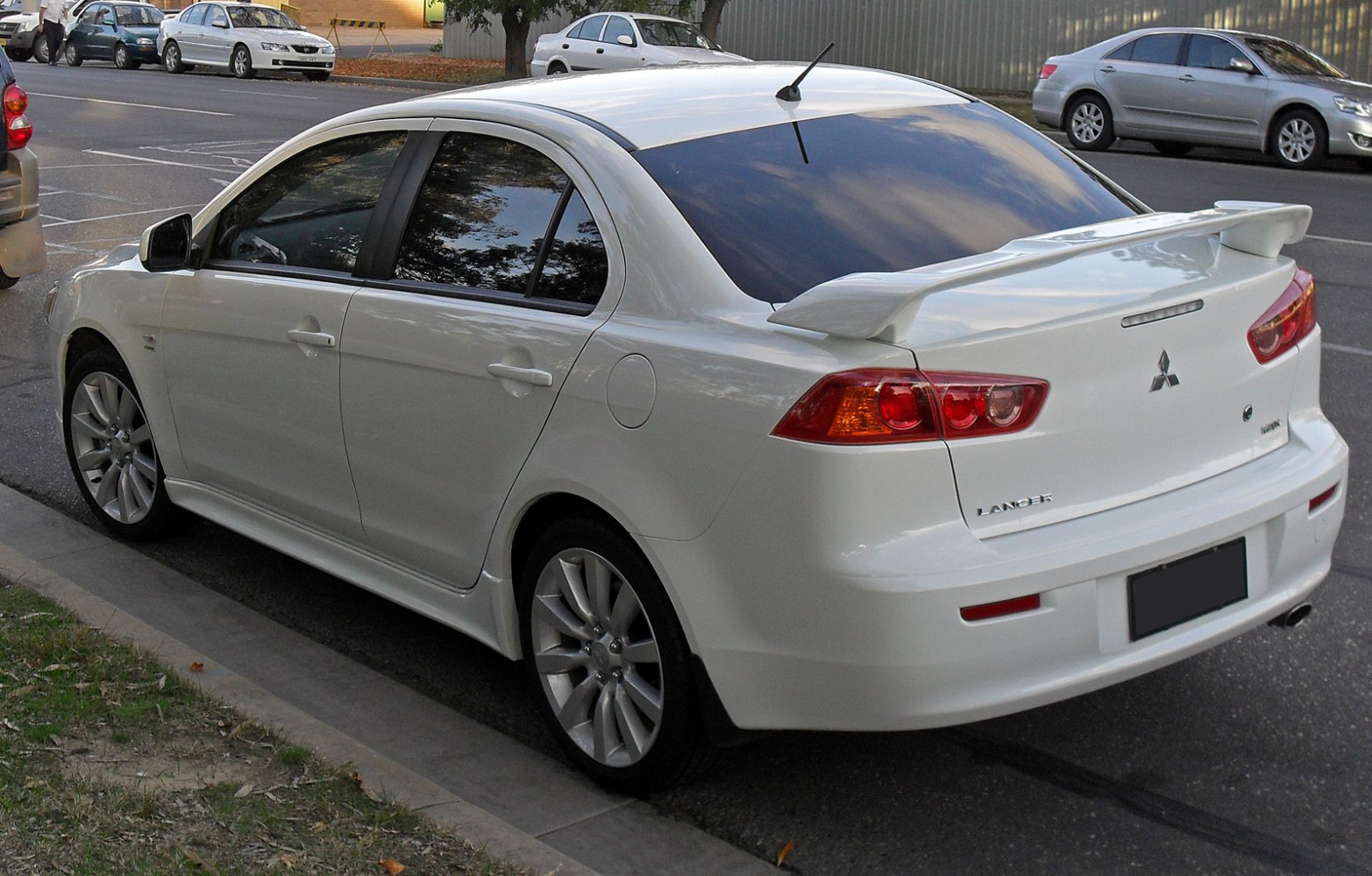 Sedan side and rear view featuring rear spoiler and alloy wheels