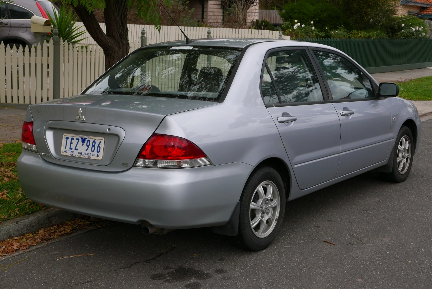 Compact sedan rear view with alloy wheels and red tail lights