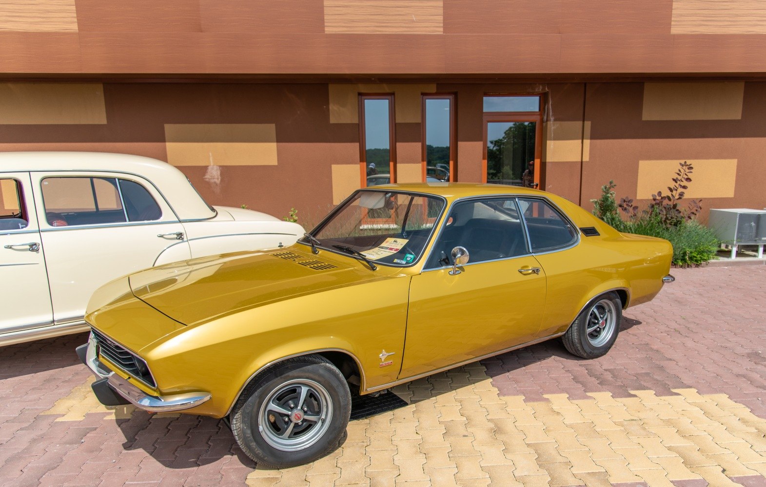 Retro 1970s coupe with front grille and alloy wheels