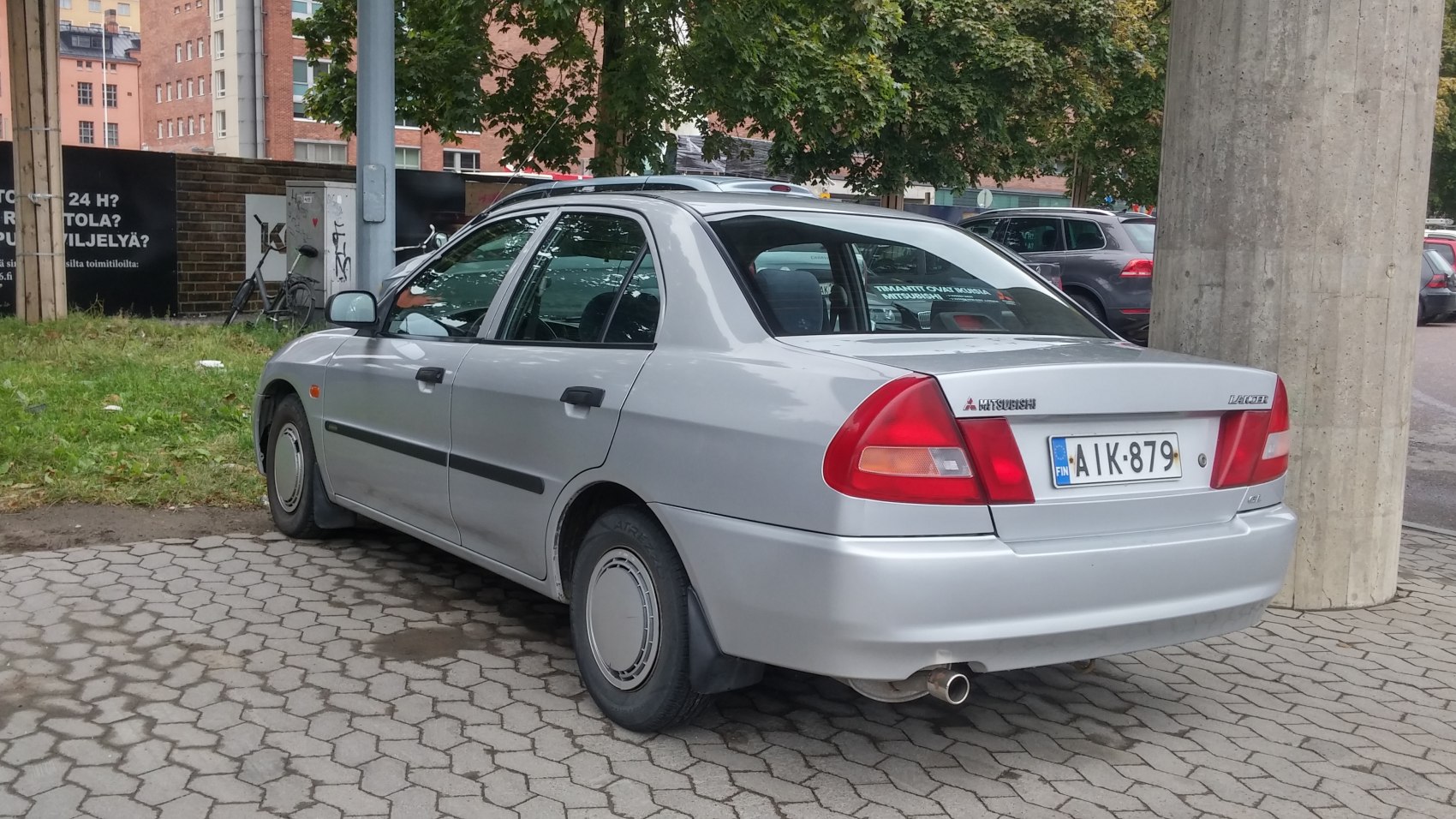 Rear and side view of silver sedan with distinct taillights