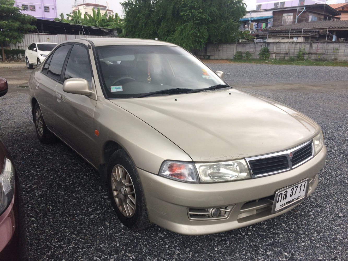 Front and side view of a sedan with alloy wheels and clear headlights