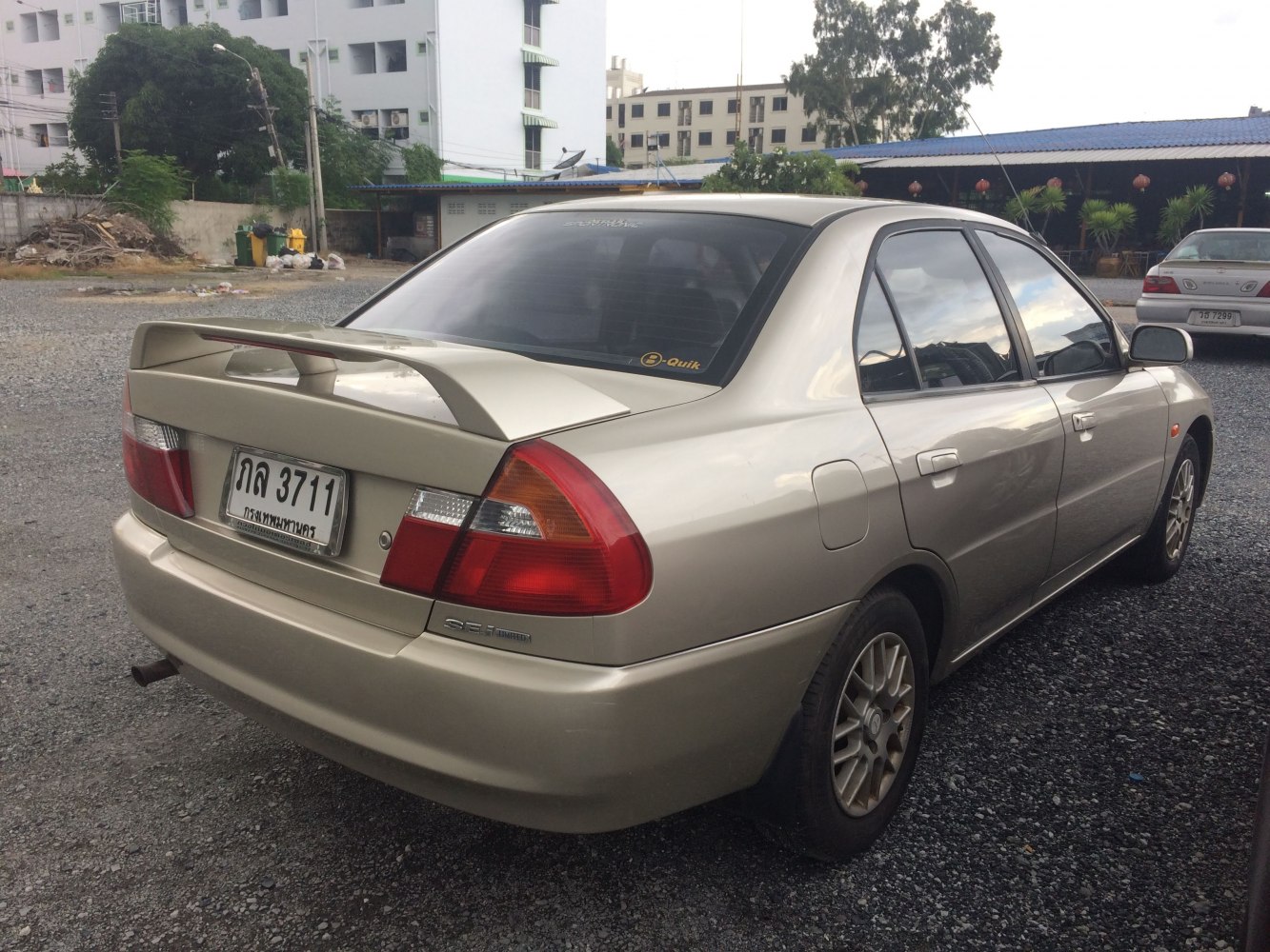 Rear view of sedan with rear spoiler and distinctive tail lights