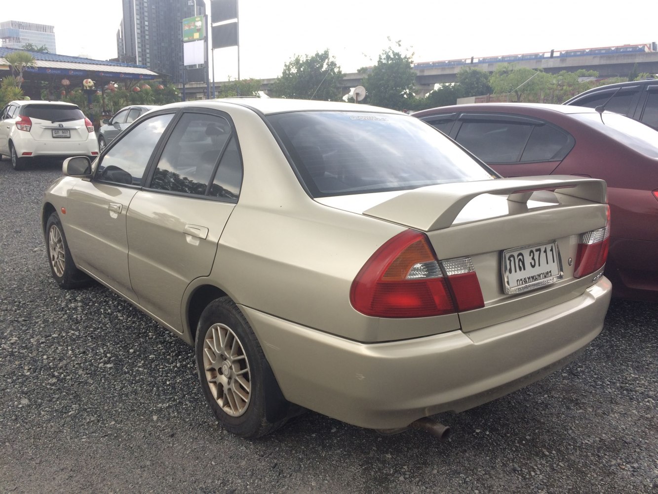 Rear view of sedan with rear spoiler and alloy wheels