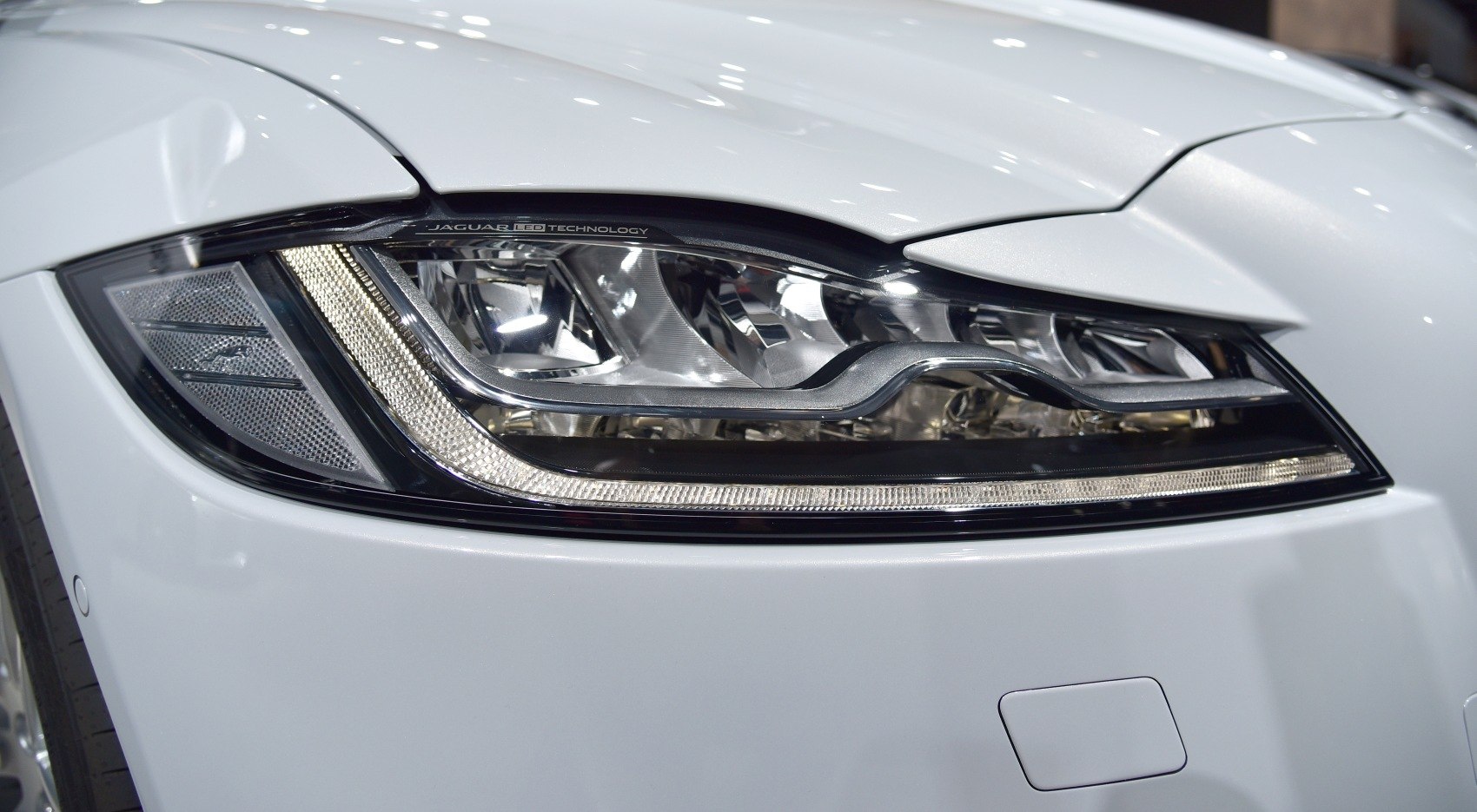 Close-up of LED headlight with sleek chrome and light strip design