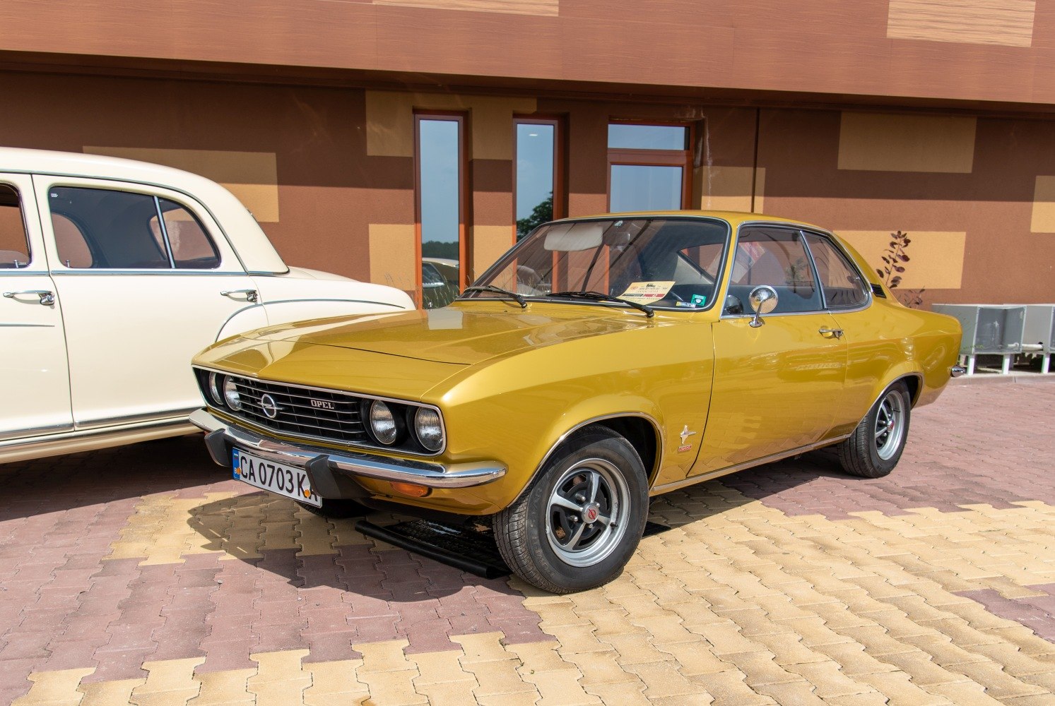 Yellow two-door coupe with dual round headlights and sporty wheels