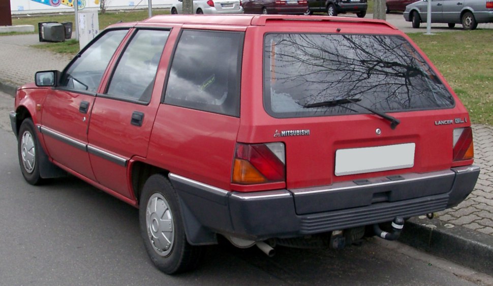 Red classic wagon rear side with rear window wiper and bumper.