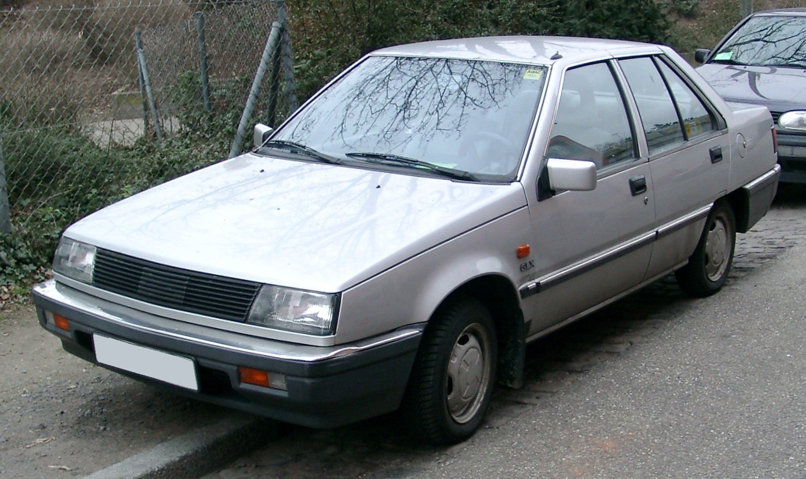 Rectangular headlights, boxy compact sedan, steel wheels