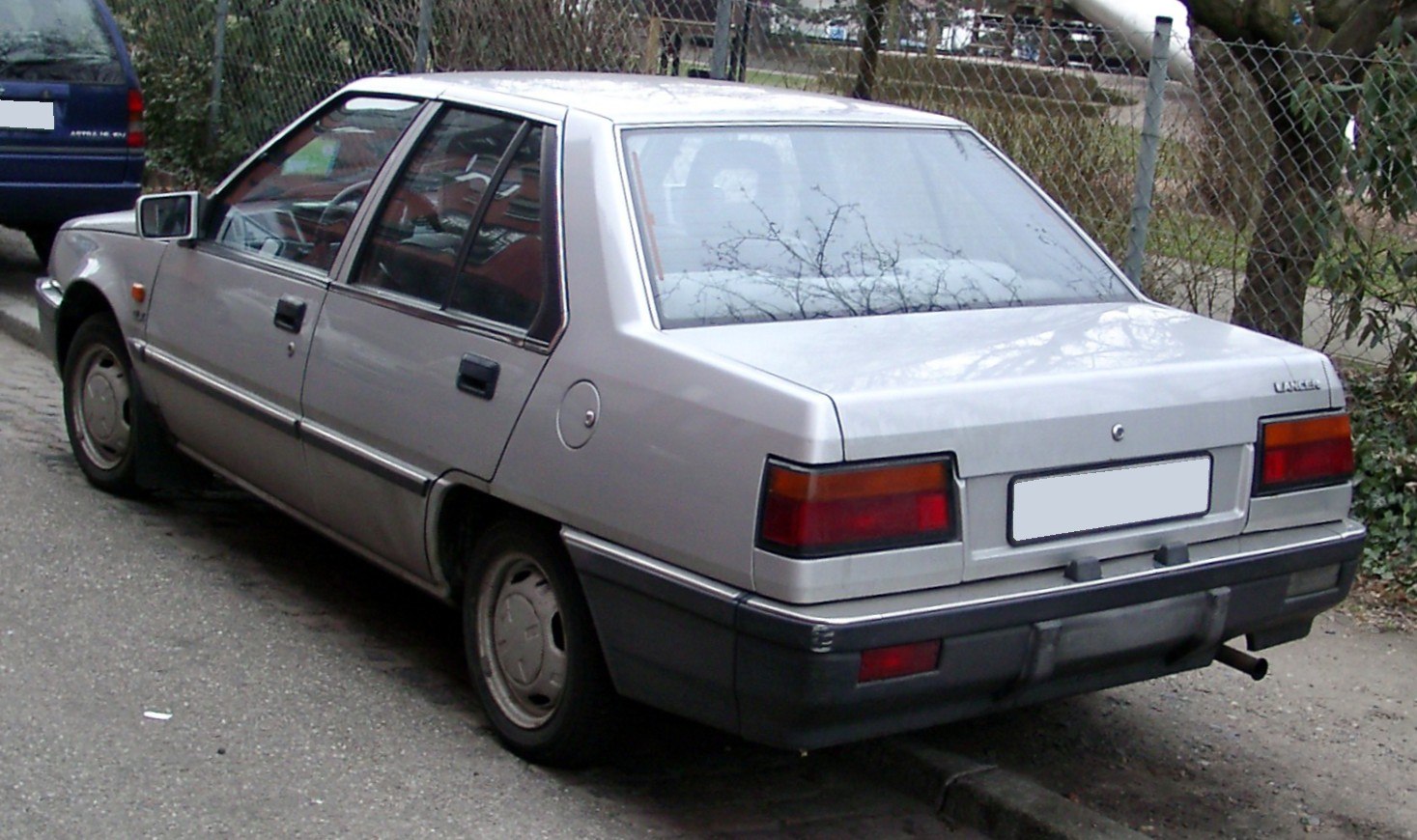 Classic 1980s sedan rear view with angular tail lights and squared design
