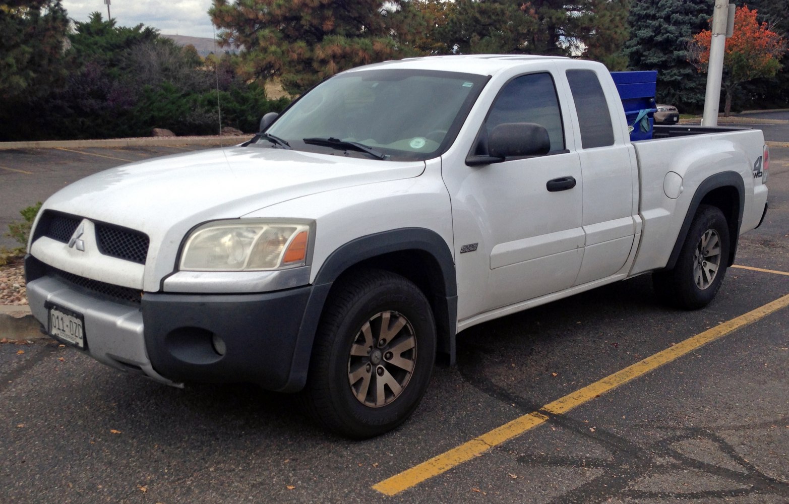 Extended cab pickup truck with rugged front grille and 4WD badge