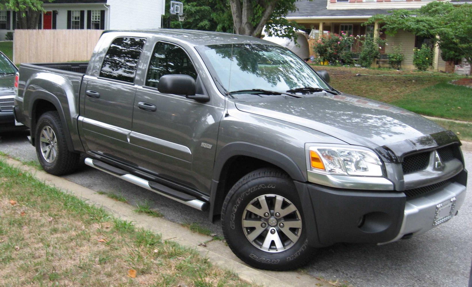 Double cab pickup with side steps and alloy wheels