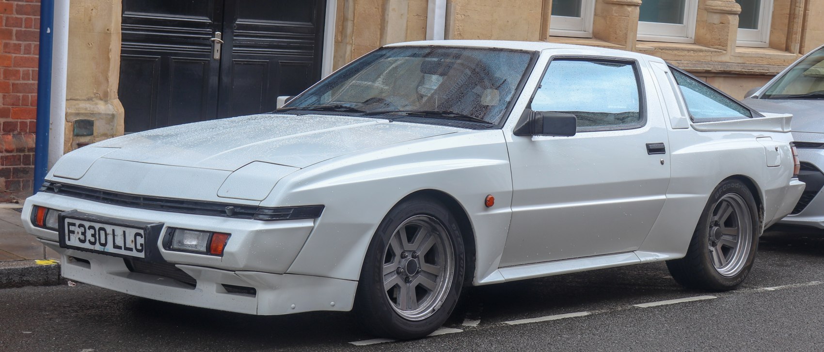 1980s sports coupe with pop-up headlights and rear spoiler