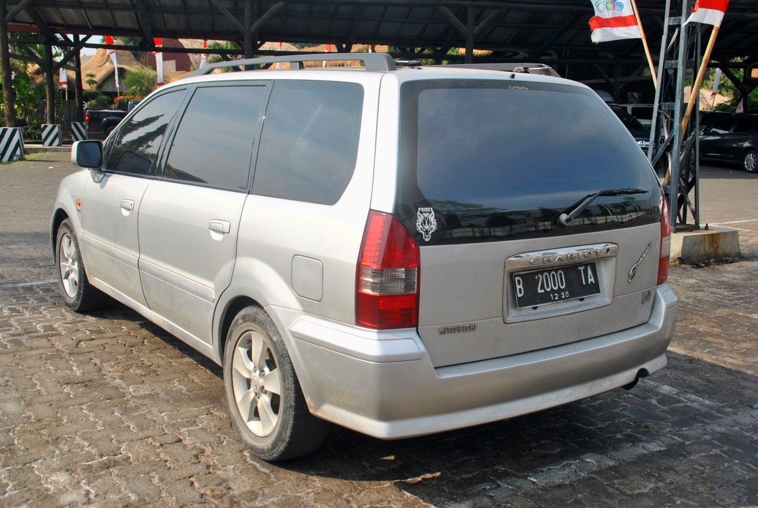 MPV rear view with tinted windows and roof rails