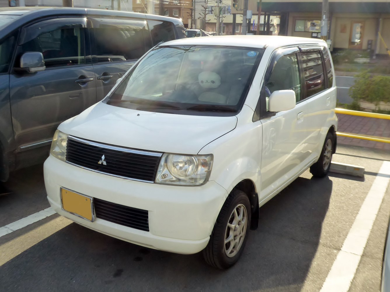 Compact white wagon with black grille and round headlights