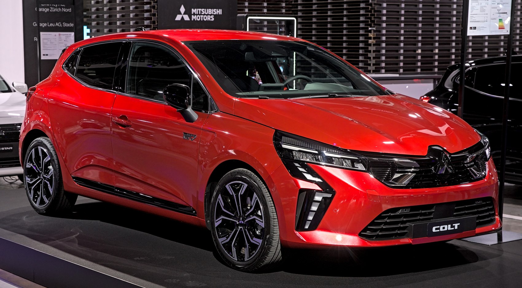 Sleek red hatchback with LED headlights and sporty black alloy wheels.