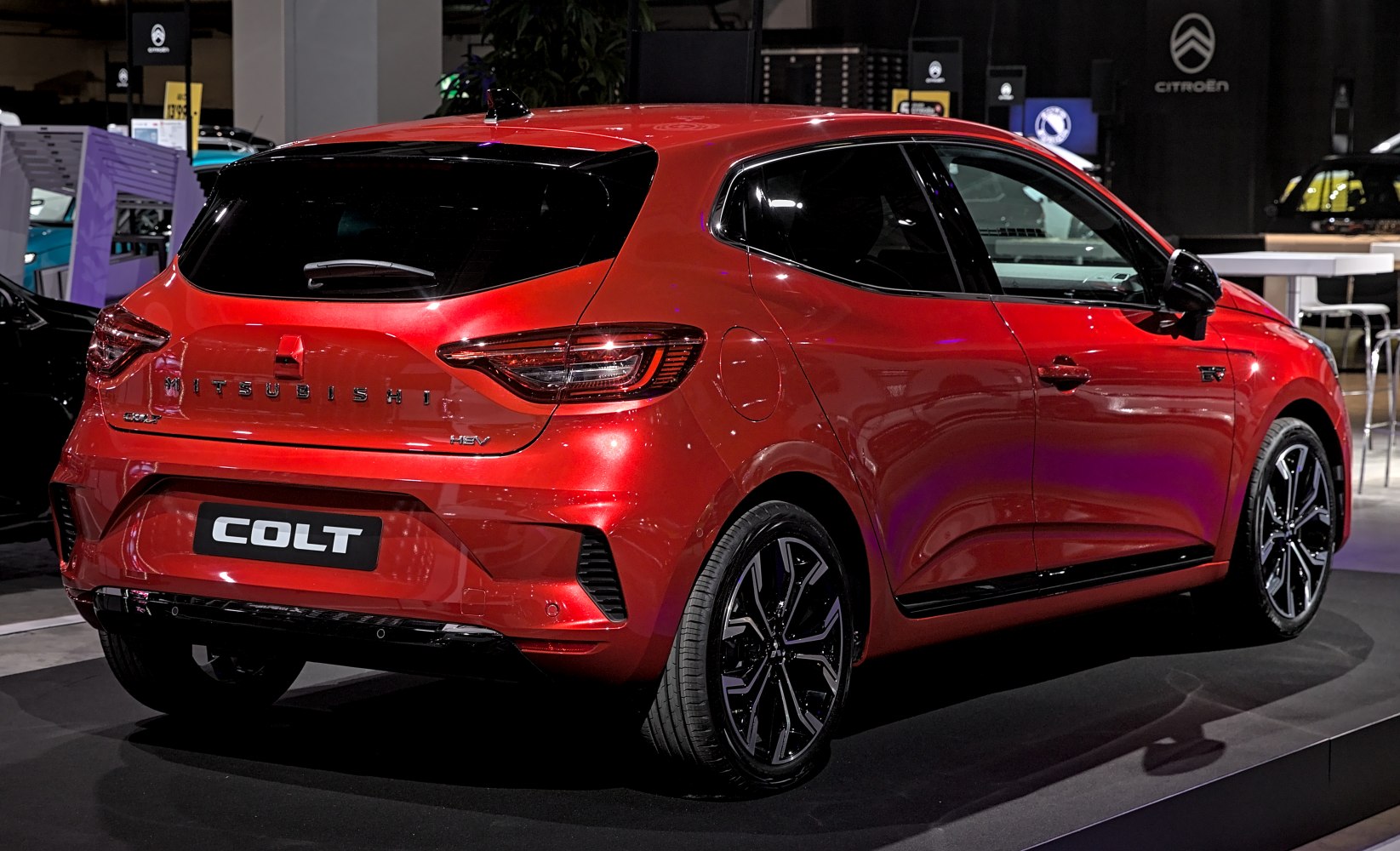 Rear and side view of red compact hatchback with modern tail lights and alloy wheels