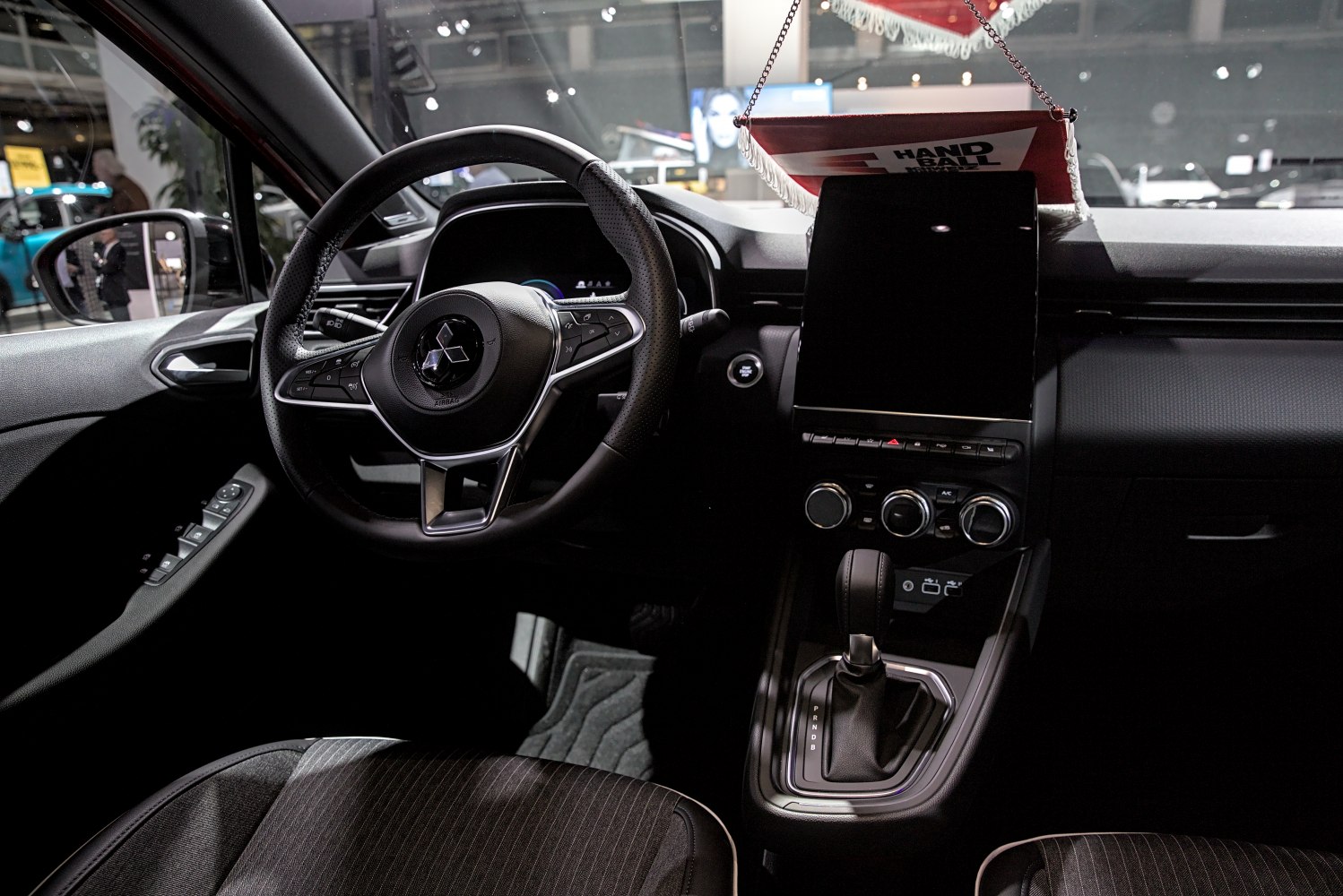 Modern car interior with multifunction steering wheel and large touchscreen display