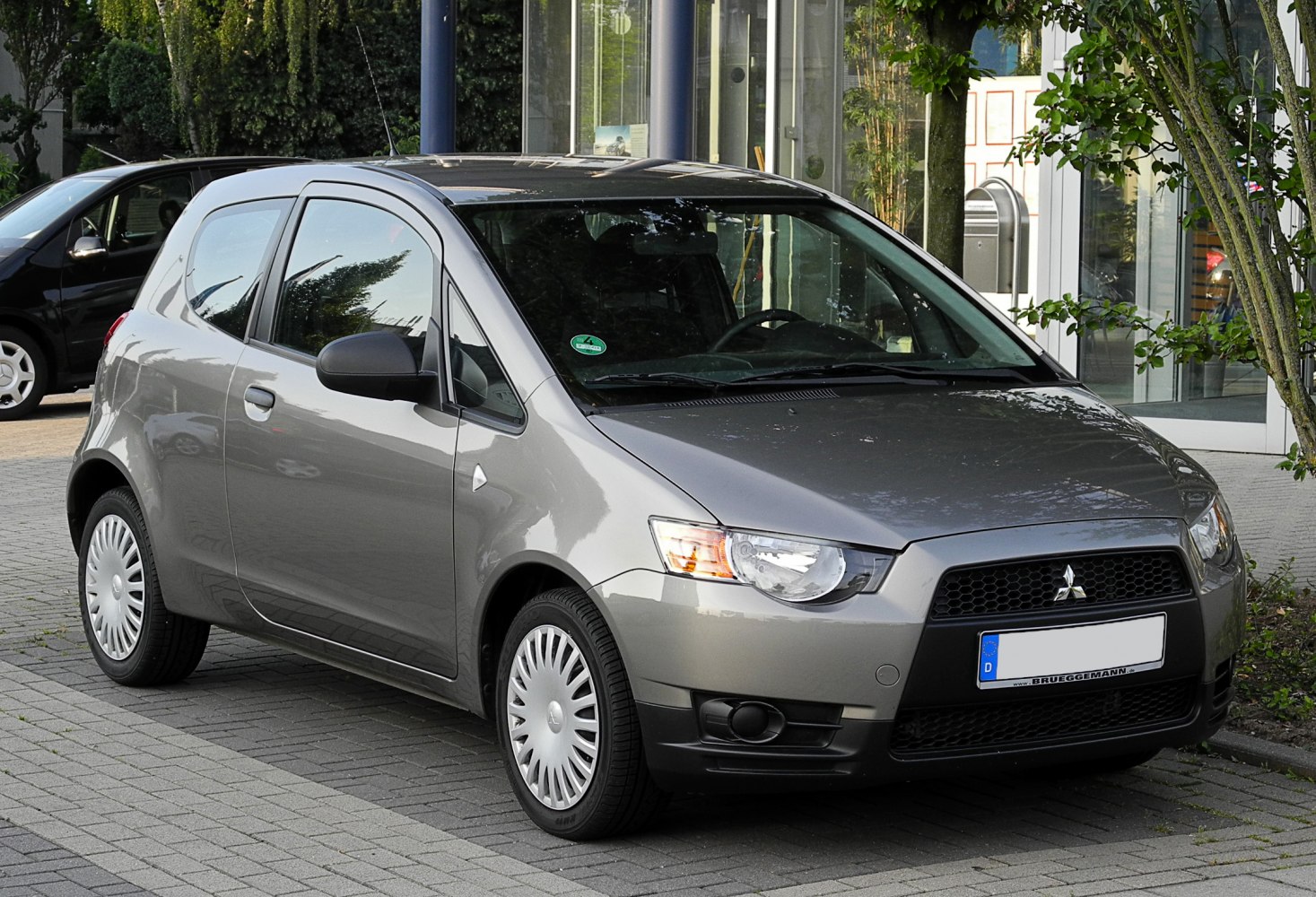 3-door compact hatchback with modern front grille and halogen headlights