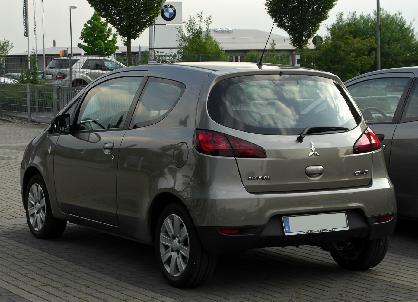 Rear view of a compact 3-door hatchback with distinctive tail lights and rear windshield wiper.